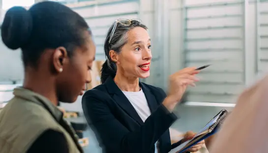 three woman standing in a well lit room