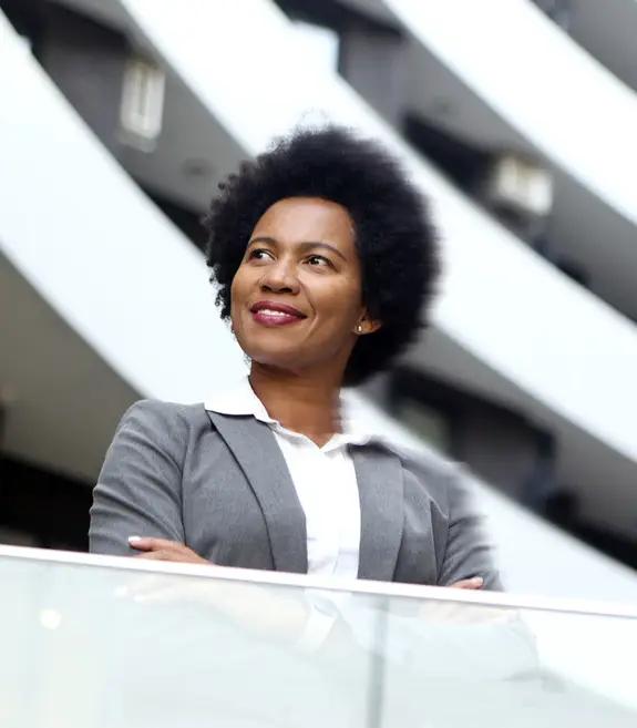 black business woman looking away with arms crossed and a dreamer look